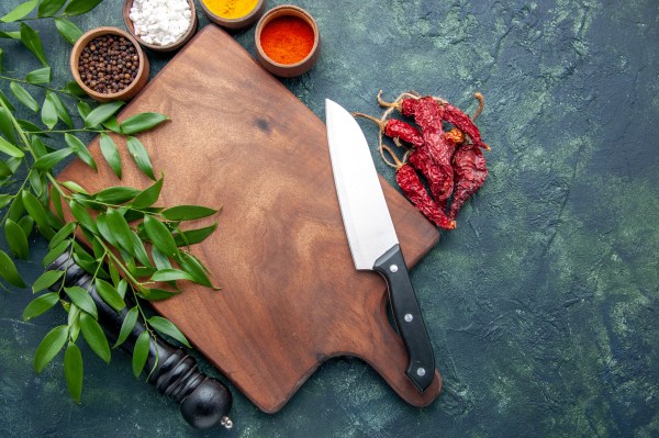 top-view-different-seasonings-with-brown-wooden-desk-dark-blue-background-color-wood-sharp-cutlery-tree-green-kitchen